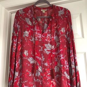 Red floral oversized V-neck blouse with long sleeves and tassels